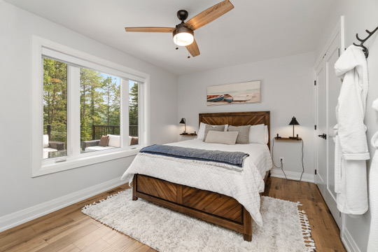 Queen bedroom with deck views at Casa Muzyka Lakehouse near Barry's Bay, Ontario