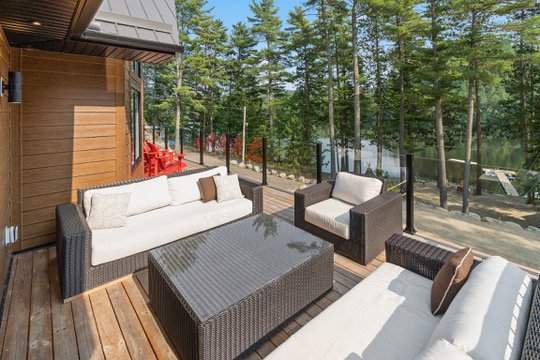 Outdoor lounge seating on the deck overlooking Dam Lake at Casa Muzyka Lakehouse