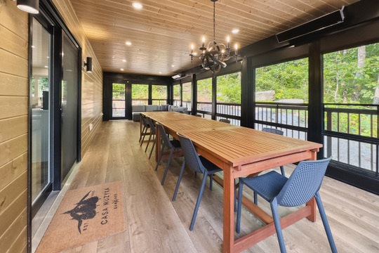 35 by 15 foot Muskoka room with long dining table at Casa Muzyka Lakehouse on Dam Lake